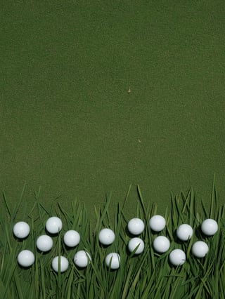 Scattered Golf Balls on Grass