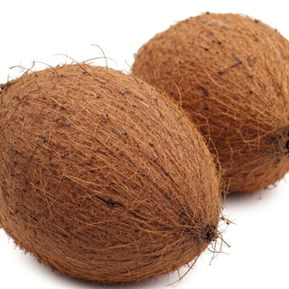 Unopened Coconuts on White Background