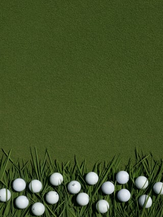 Scattered Golf Balls on Grass